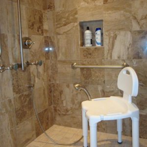chair has holder for shower head with hose