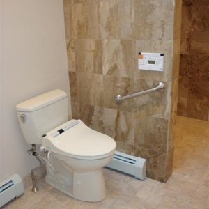 ADA height toilet with Toto bidet seat; remote control with multi-functions on wall