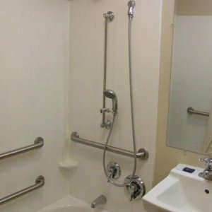 Faucet handle is low and close to the edge of the tub for easy access
the hand-held shower is on a slide mount bar for multiple positions, i think ano